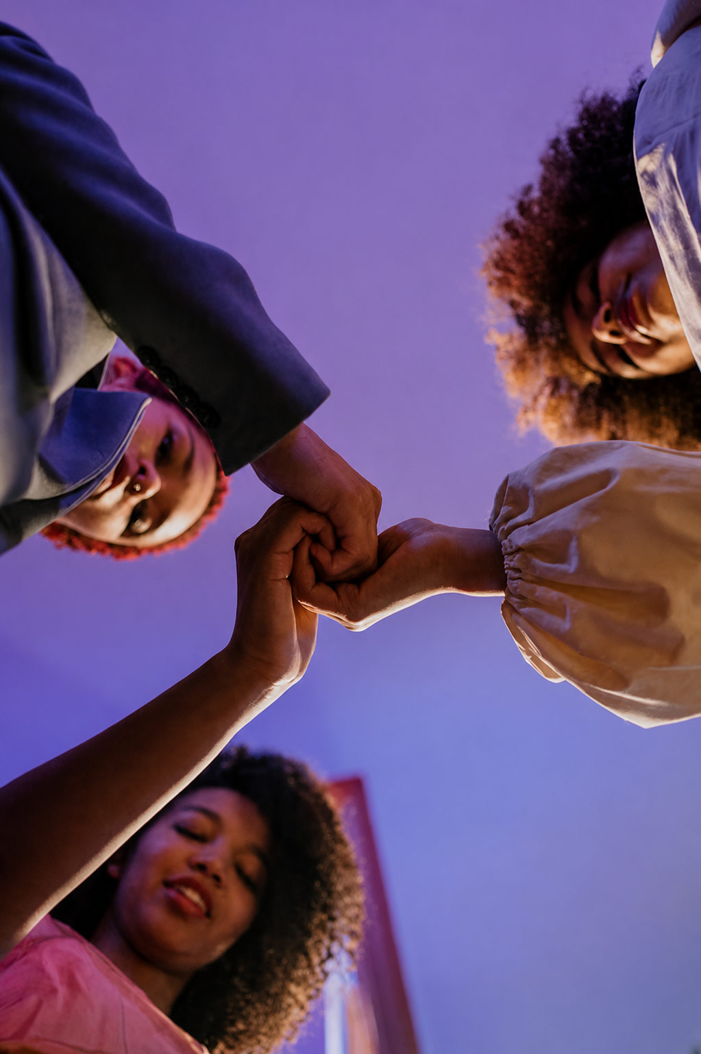 Friends joining hands in a circle